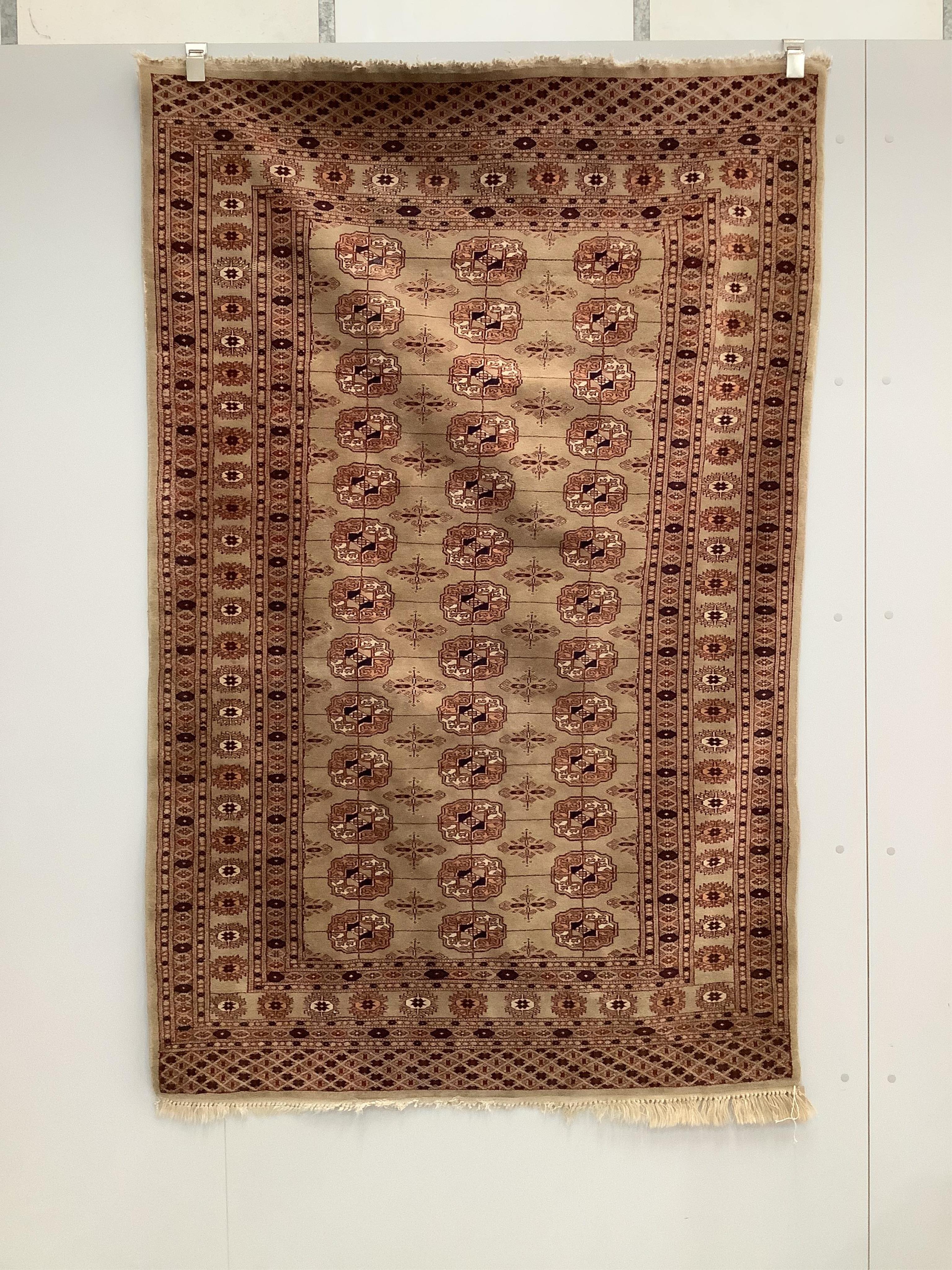 A Bokhara fawn ground rug, 190 x 120cm. Condition - fair